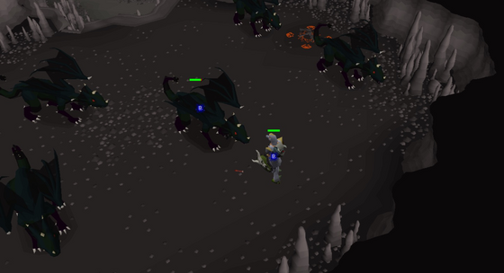Surrounded by black dragons in their cavern of the Slayer Cave