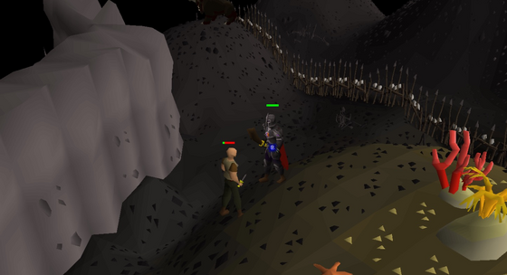 Fighting a rogue on the path beside the Mage Bank's spiked fence, Wilderness level 50