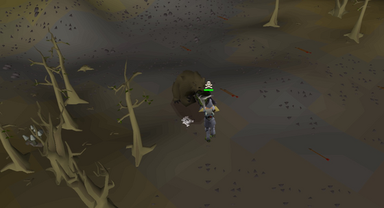 A grizzly bear mauling the player among the dead trees of level 9 Wilderness